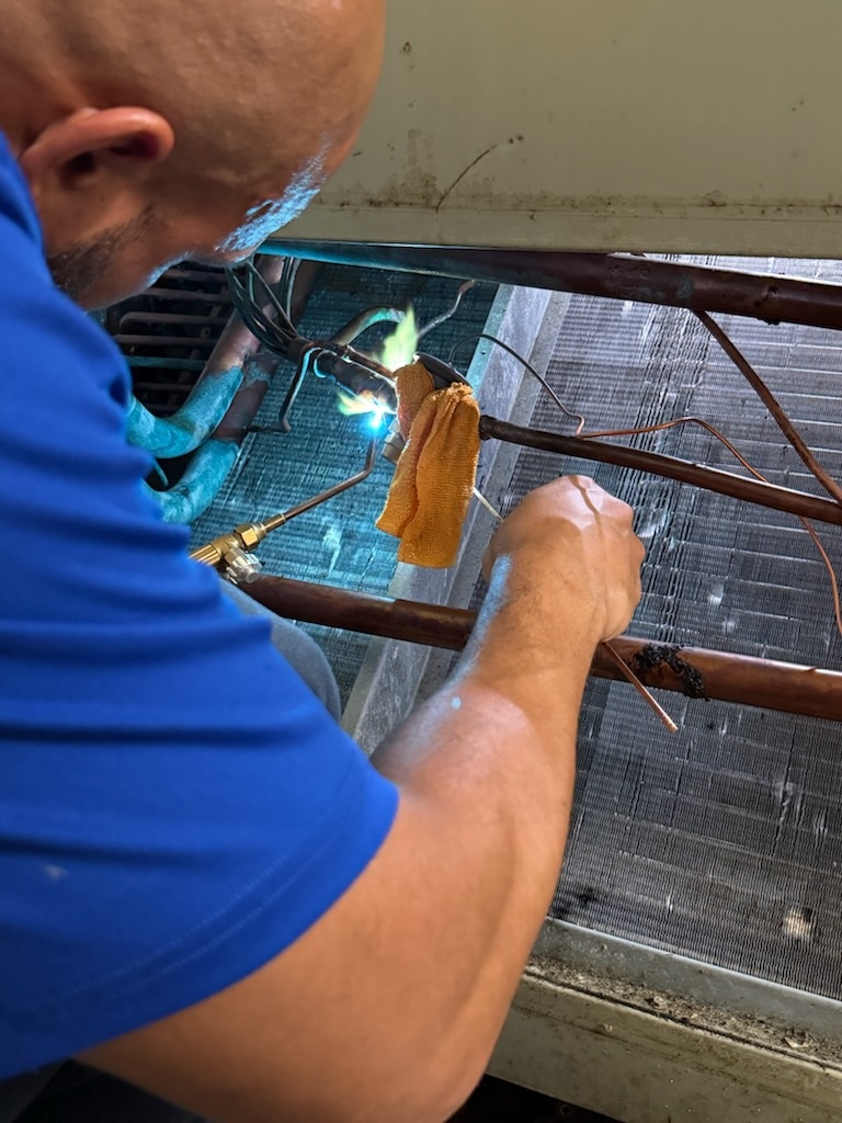 HVAC technician performing comprehensive system maintenance